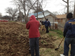 Volunteers using shovels to prepare vacant lot